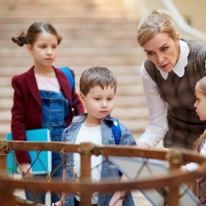 Teacher guiding schoolkids in museum of national history